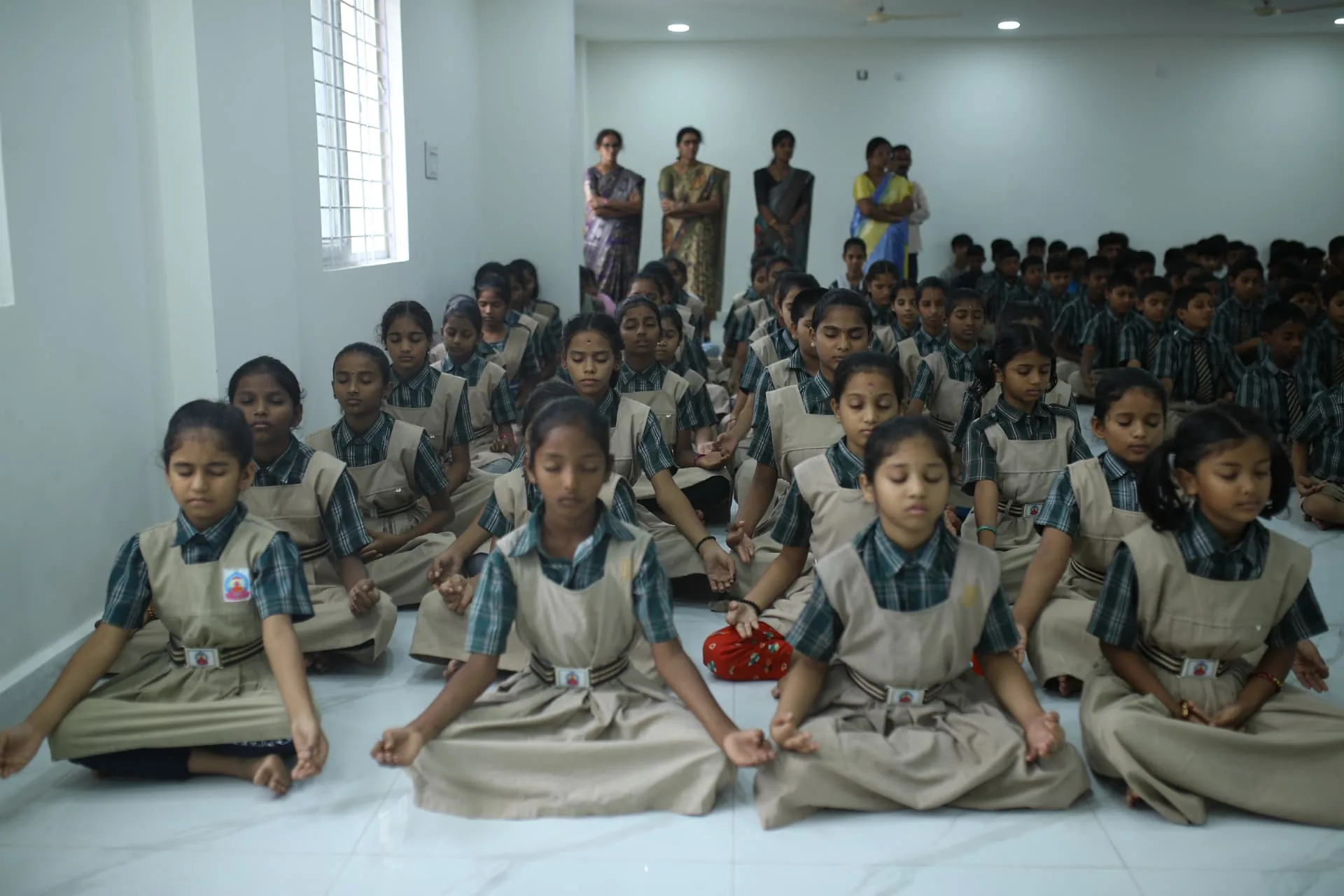 Aadarana students meditating together in the school hall
